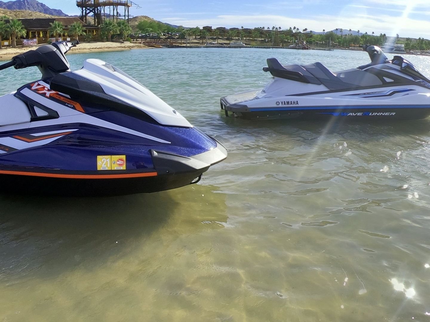 Two jet skis in shallow water near the shore